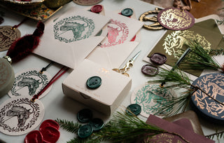 A selection of foil-stamped greeting cards, gift tags, wax seals and holiday ornaments featuring horse and equestrian holiday motifs drawn and designed by Danielle Demers equine artist.