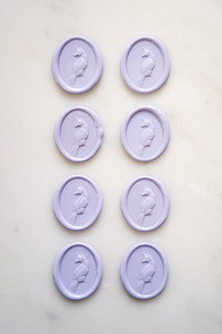 Photo of a set of eight lavender wax seals featuring fox designs created by equine artist Danielle Demers