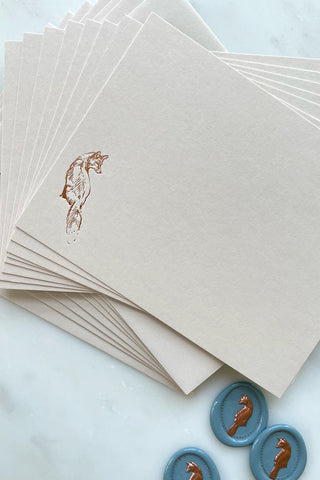 Photo of a correspondence card and matching envelope. Card features a copper foil stamped drawing of a sitting fox by equine artist Danielle Demers.
