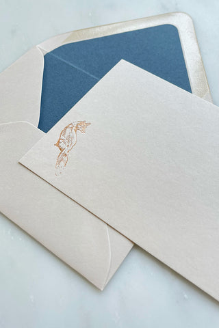 Photo of a correspondence card and matching envelope. Card features a copper foil stamped drawing of a sitting fox by equine artist Danielle Demers.