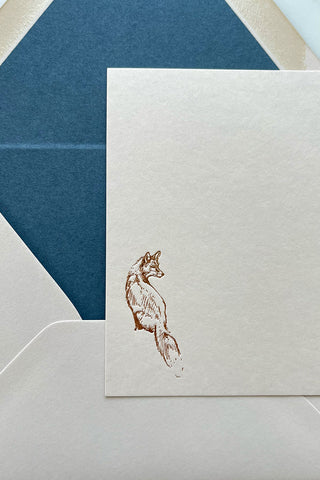 Photo of a correspondence card and matching envelope. Card features a copper foil stamped drawing of a sitting fox by equine artist Danielle Demers.