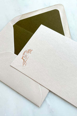Photo of a correspondence card and matching envelope. Card features a copper foil stamped drawing of a sitting fox by equine artist Danielle Demers.