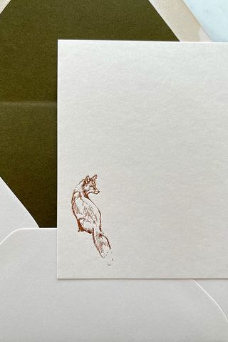 Photo of a correspondence card and matching envelope. Card features a copper foil stamped drawing of a sitting fox by equine artist Danielle Demers.