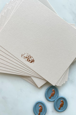 Photo of a correspondence card and matching envelope. Card features a copper foil stamped drawing of a sleeping fox by equine artist Danielle Demers.