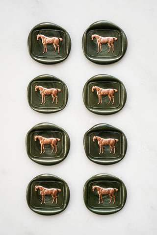 Photo of a set of 8 metallic forest green standing horse wax seals with copper hand painted details by Danielle Demers