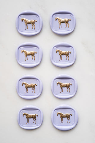 Photo of a set of 8 lavender standing horse wax seals with gold hand painted details by Danielle Demers
