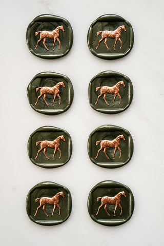 Photo of a set of 8 metallic forest green horse wax seals with copper hand painted detail by equine artist Danielle Demers