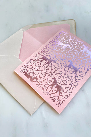 Photo of a foil-stamped note card featuring a horse and oak leaf and branch pattern printed in metallic lilac foil on a soft pink card stock by equine artist Danielle Demers.