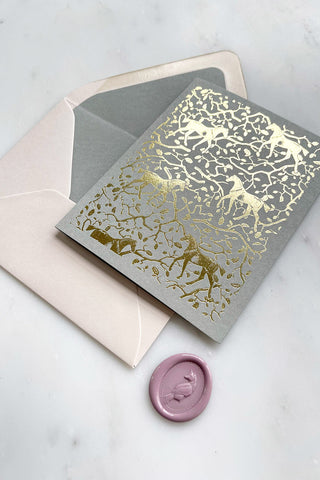 Photo of a foil-stamped note card featuring a horse and oak leaf and branch pattern printed in metallic gold foil on a muted sage card stock by equine artist Danielle Demers.