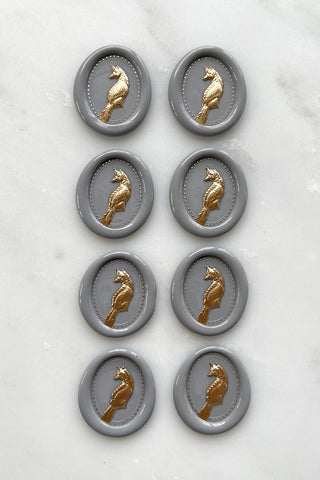 Photo of a set of 8 grey fox wax seals with gold painted details by Danielle Demers