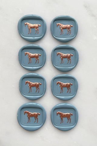 Photo of a set of 8 French blue standing horse wax seals with copper hand painted details by Danielle Demers