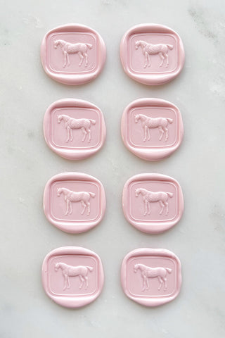 Photo of a set of 8 petal pink wax seals featuring a standing horse design by Danielle Demers.