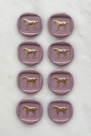 Photo of a set of 8 dusty rose standing horse wax seals with gold hand painted details by Danielle Demers