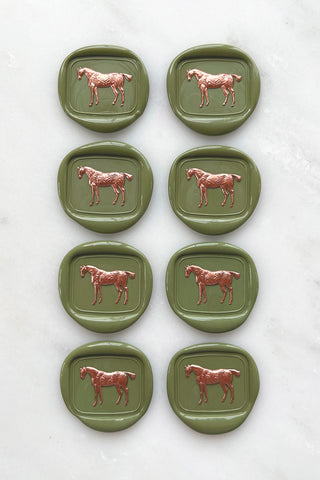 Photo of a set of 8 sap green standing horse wax seals with copper hand painted details by Danielle Demers