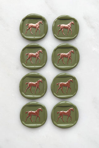 Photo of a set of 8 sap green horse wax seals with copper hand painted detail by equine artist Danielle Demers