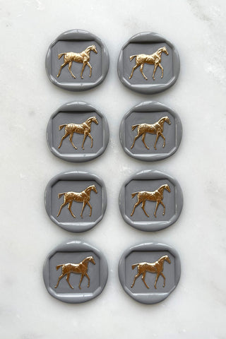 Photo of a set of 8 grey horse wax seals with gold hand painted detail by equine artist Danielle Demers