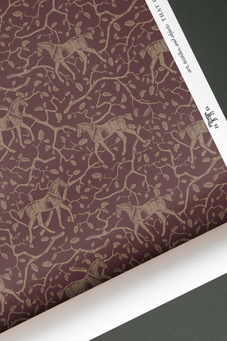 Roll of Amongst the Oaks horse motif wallpaper in the colorway "Bordeaux." Designed by equine artist Danielle Demers.