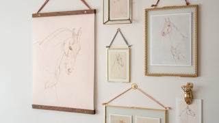 Photo of a gallery wall of framed horse drawing prints by equine artist Danielle Demers