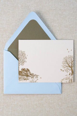 Foil stamped correspondence card featuring a summer scene with a horse, deer, lavender, roses, trees and birds. Gold foil design on cream card stock with a light blue envelope lined in a muted moss green liner.