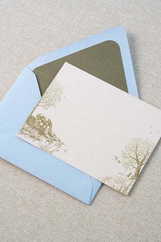 Foil stamped correspondence card featuring a summer scene with a horse, deer, lavender, roses, trees and birds. Gold foil design on cream card stock with a light blue envelope lined in a muted moss green liner.