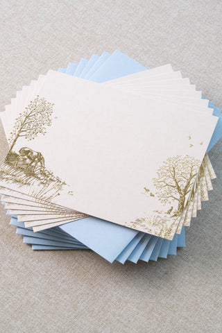 Set of eight foil stamped correspondence cards featuring a summer scene with a horse, deer, lavender, roses, trees and birds. Gold foil design on cream card stock with a light blue envelope lined in a muted moss green liner.