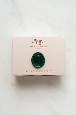 Wax seals are packaged in a small foil stamped box designed and printed in studio.