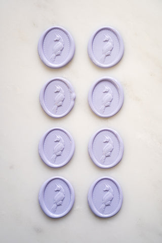 Photo of a set of eight lavender wax seals featuring fox designs created by equine artist Danielle Demers