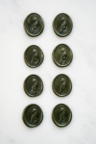 Photo of a set of eight metallic forest green wax seals featuring fox designs created by equine artist Danielle Demers