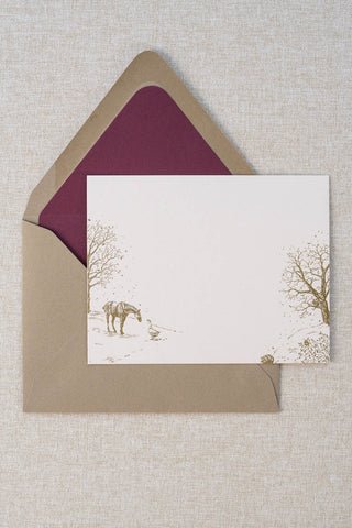 Foil stamped correspondence card featuring a winter scene with a horse, goose, hedgehog, robin, trees and snow. Gold foil design on cream card stock with a taupe envelope lined in a deep cranberry liner.