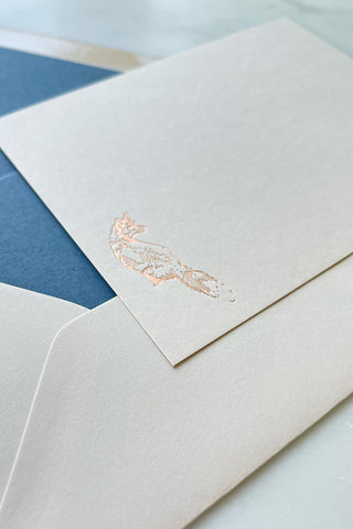 Photo of a correspondence card and matching envelope. Card features a copper foil stamped drawing of a sitting fox by equine artist Danielle Demers.