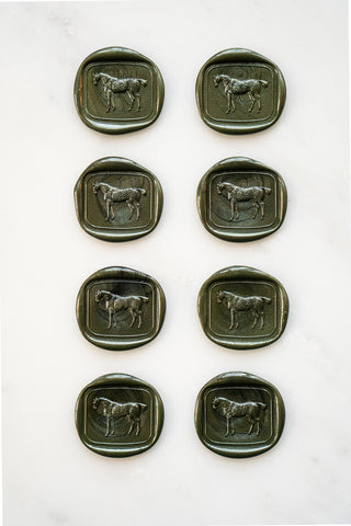 Photo of a set of 8 metallic forest green wax seals featuring a standing horse design by Danielle Demers.