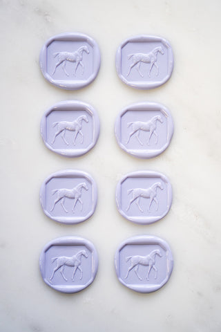 Photo of a set of 8 lavender wax seals featuring a walking horse design by Danielle Demers.
