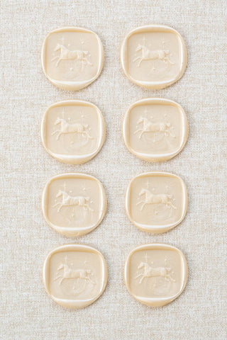 Set of eight metallic cream / champagne wax seals with a horse and stars motif 