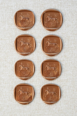 Set of eight metallic copper wax seals with a horse and stars motif 