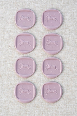 Set of eight mauve wax seals with a horse and stars motif 