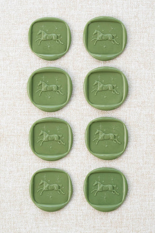 Set of eight sap green wax seals with a horse and stars motif 