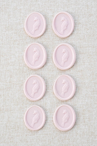 Set of eight light pink fox motif wax seals