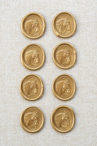 Set of eight metallic gold wax seals with a horse head motif 