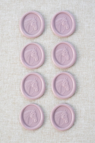 Set of eight mauve wax seals with a horse head motif 