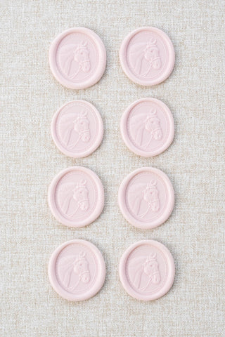 Set of eight light pink wax seals with a horse head motif 