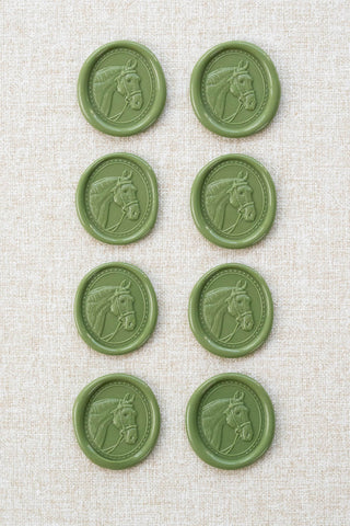 Set of eight sap green wax seals with a horse head motif 