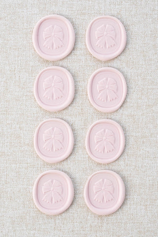 Set of eight light pink equestrian rosette motif wax seals