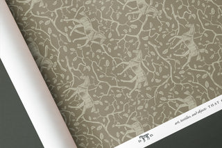 Roll of horse and oak branch and leaf patterned wallpaper by equine artist Danielle Demers.