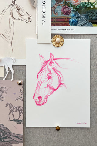 Photograph of an inspiration pin board in Danielle Demers Studio featuring a marker sketch of a pink horse