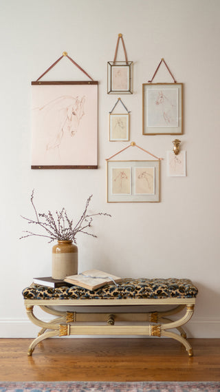 Photo of a styled gallery wall of framed mixed media drawings of horses by equine artist Danielle Demers