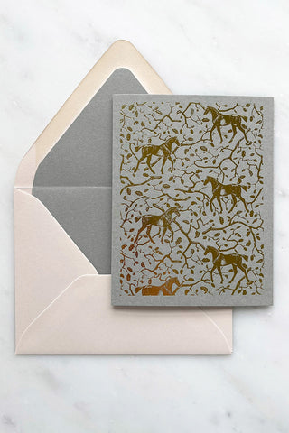 Photo of a foil-stamped note card featuring a horse and oak leaf and branch pattern printed in metallic gold foil on a muted sage card stock by equine artist Danielle Demers.