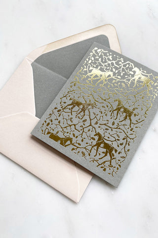 Photo of a foil-stamped note card featuring a horse and oak leaf and branch pattern printed in metallic gold foil on a muted sage card stock by equine artist Danielle Demers.