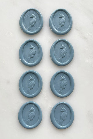 Photo of a set of eight French blue wax seals featuring fox designs created by equine artist Danielle Demers