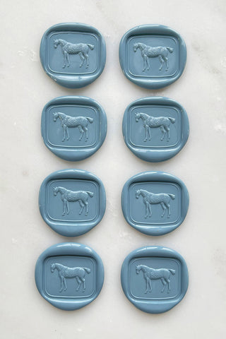 Photo of a set of 8 french blue wax seals featuring a standing horse design by Danielle Demers.