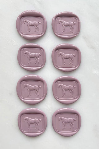 Photo of a set of 8 dusty rose wax seals featuring a standing horse design by Danielle Demers.